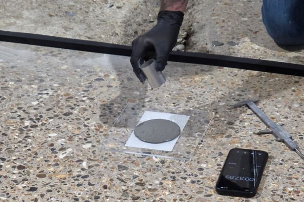 Concrete floor colour and finish sample being tested during the polishing process