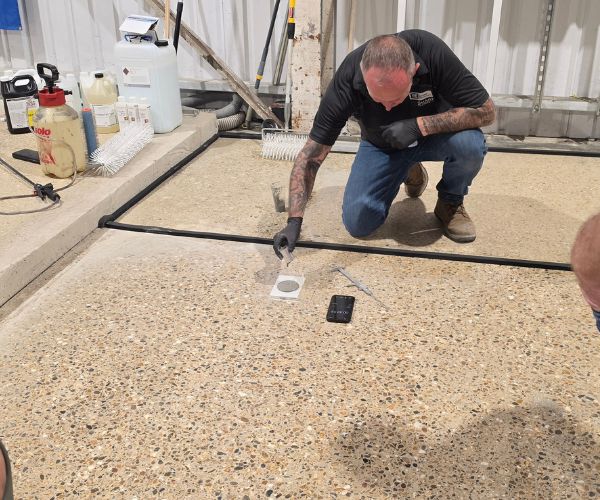 StoneCura testing a TRU polished concrete overlay during certified installer training